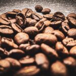 brown coffee beans on black surface
