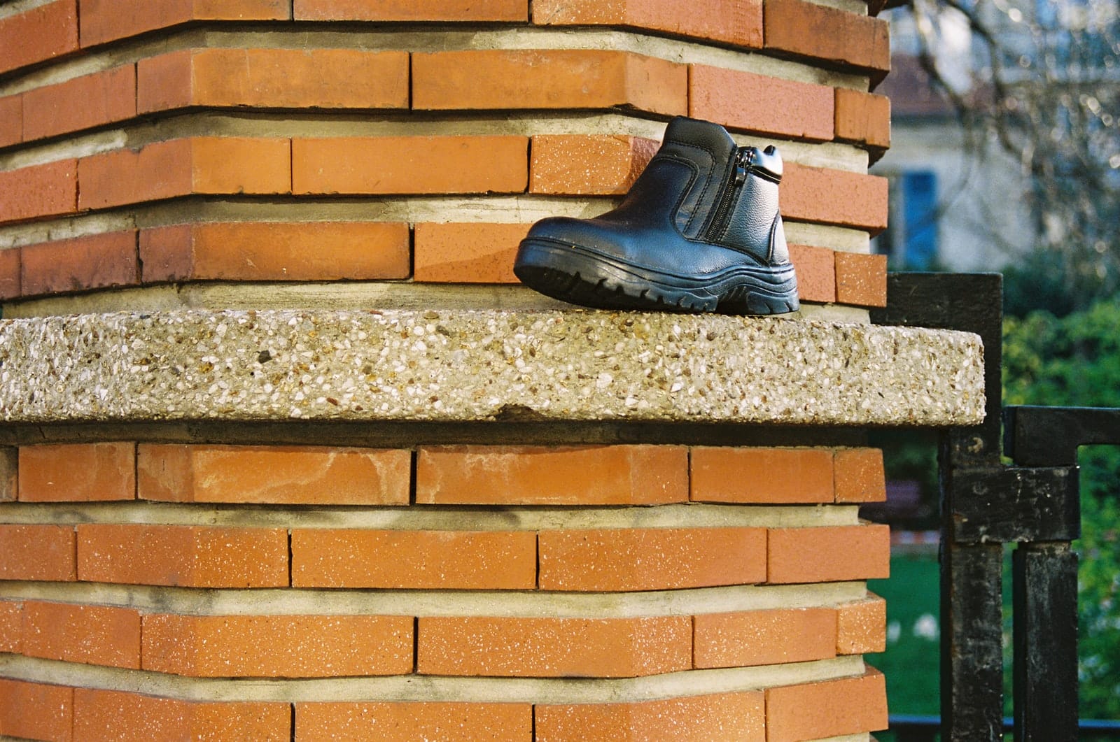 black leather work boots on gray concrete stairs