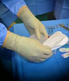 person in blue long sleeve shirt holding white paper